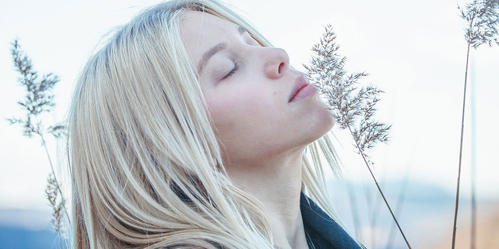 blonde women closes eyes and relaxes