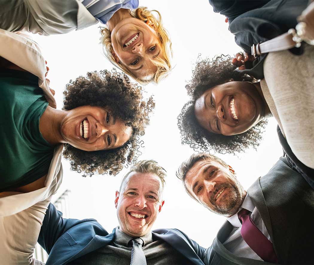 looking up at 5 smiling people in a circle